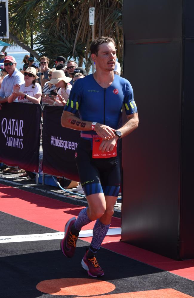 Athletes crossing the finish line at the Sunshine Coast Ironman 70.3 2023.