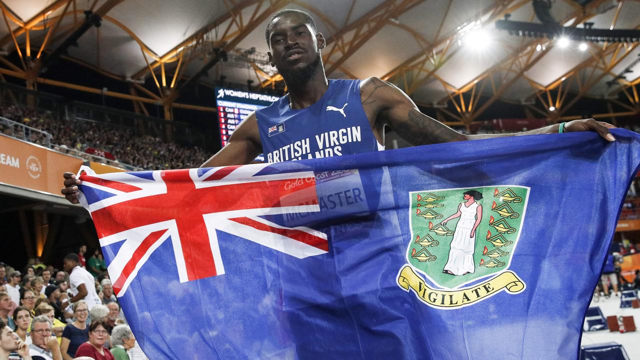 British Virgin Islands’ Kyron Mcmaster celebrates winning the athletics men's 400m hurdles final during the 2018 Gold Coast Commonwealth Games at the Carrara Stadium on the Gold Coast on April 12, 2018. / AFP PHOTO / Adrian DENNIS