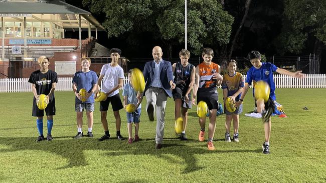 Simon Kennedy (centre) with young players at George Kendall Riverside Park, Ermington.