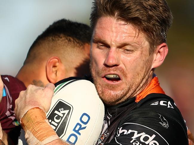 SYDNEY, AUSTRALIA - JULY 16: Chris Lawrence of the Tigers is tackled during the round 19 NRL match between the Manly Sea Eagles and the Wests Tigers at Lottoland on July 16, 2017 in Sydney, Australia.  (Photo by Cameron Spencer/Getty Images)