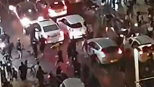 This video grab obtained from a footage released by Kan 11 Public broadcaster on May 12, 2021, shows a far-right Israeli mob attacking who they considered an Arab man, on the seafront promenade of Bat Yam. Picture: AFP PHOTO/HO/ Kan 11 Public Broadcaster