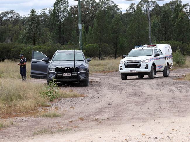 Police block the unsealed Wains Road, Wieambilla, leading to the property where two police officers and a neighbour were killed. Picture: Liam Kidston