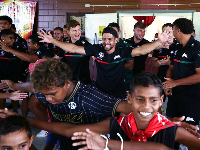 South Sydney Rabbitoh's Cody Walker leads his team in a traditional dance with Yarrabah children at Yarrabah's Jilara Oval earlier this year. The Rabbitoh visited Yarrabah for a player autograph session, a traditional welcome and dance performance ahead of their NRL pre season match against the North Queensland Cowboys. Picture: Brendan Radke