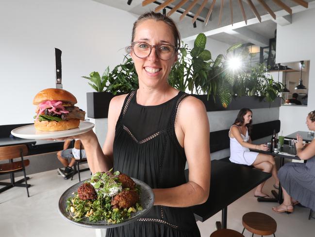 Popular Gold Coast eateries are creating their own little empires by opening spin off cafes and restaurants across the Coast. The people behind popular coffee shop Barefoot Barista at Palm Beach have just opened a new coffee shop at Mermaid Beach called Background Barista.Photo of owner Liz Ennis at the new cafe with Zucchini fritters (for the girls) and a Rib-Wish Burger (for the boys)Photo by Richard Gosling