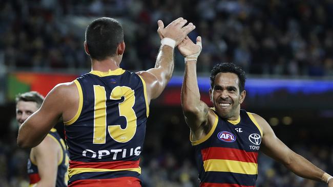 Eddie Betts celebrates his amazing goal from the boundary with co-captain Taylor Walker. Picture SARAH REED