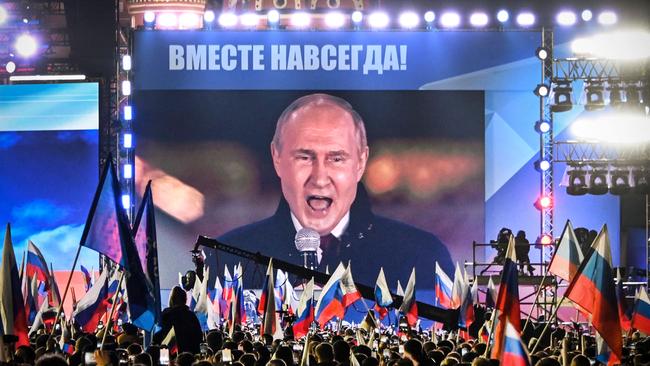 Russian President Vladimir Putin is seen on a screen at Red Square as he addresses a rally and a concert marking the annexation of four regions of Ukraine. Picture: AFP