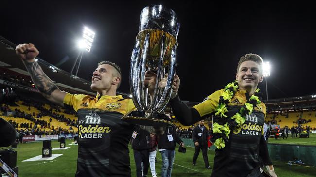 TJ Perenara and Beauden Barrett of the Hurricanes celebrate with the Super Rugby trophy after the Hurricanes won the 2016 final against the Lions.