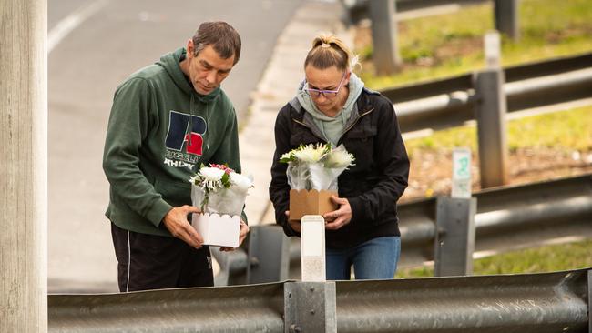 A couple stop by the crash site on Saturday to leave flowers. Picture: Julian Andrews