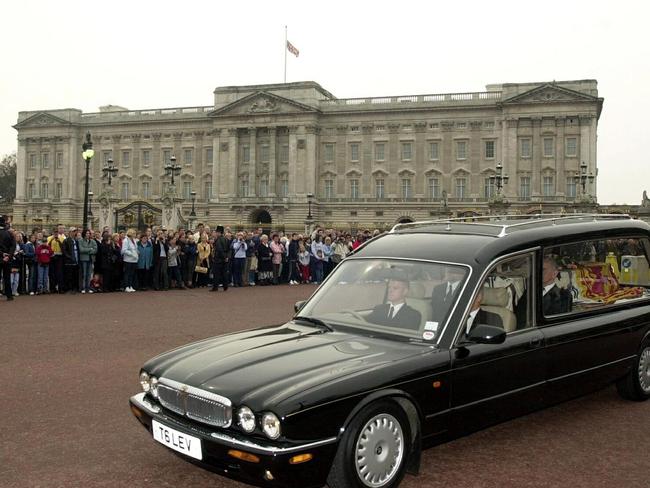 A hearse carrying the Queen Mother passes Buckingham Palace on its way to her funeral. Picture: AFP