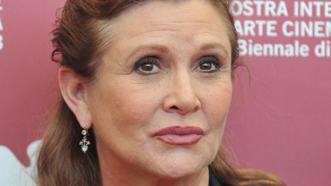 (FILES) This file photo taken on August 28, 2013 shows US actress and scriptwriter Carrie Fisher posing during a photocall of the jury on the first day of the 70th Venice Film Festival at Venice Lido.  "Star Wars" actress Carrie Fisher is in a  "stable condition" following her heart attack, her mother, actress Debbie Reynolds, tweeted on December 25 in a Christmas Day message. "Carrie is in a stable condition. If there is a change, we will share it," Reynolds said on Twitter. Fisher, 60, is in a Los Angeles hospital after suffering a massive heart attack near the end of a flight from London on December 23.  / AFP PHOTO / TIZIANA FABI