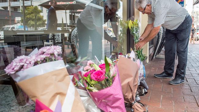 Mourners lay flowers at the site where underworld lawyer Joe Acquaro was killed. Picture: Jake Nowakowski