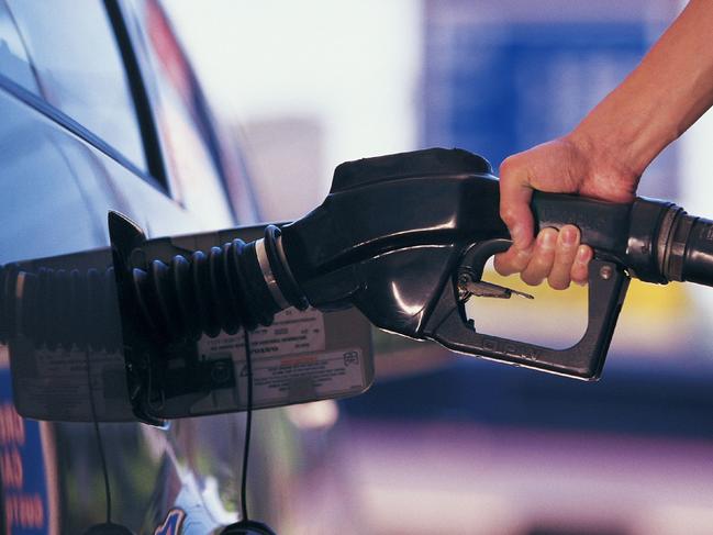 Man pumping fuel into his car.