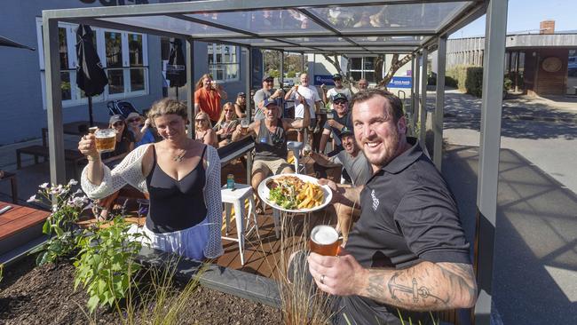 From Parking to Parmis! Parklet suppoer supporter Frankie Kaye of Swell Cafe and Beach Hotel supervisor Paul Wilkins with happy alfresco customers. Surf Coast Shire Councils Parklet Pilot Program has begun at the Beach Hotel in Jan Juc. Picture: Alan Barber