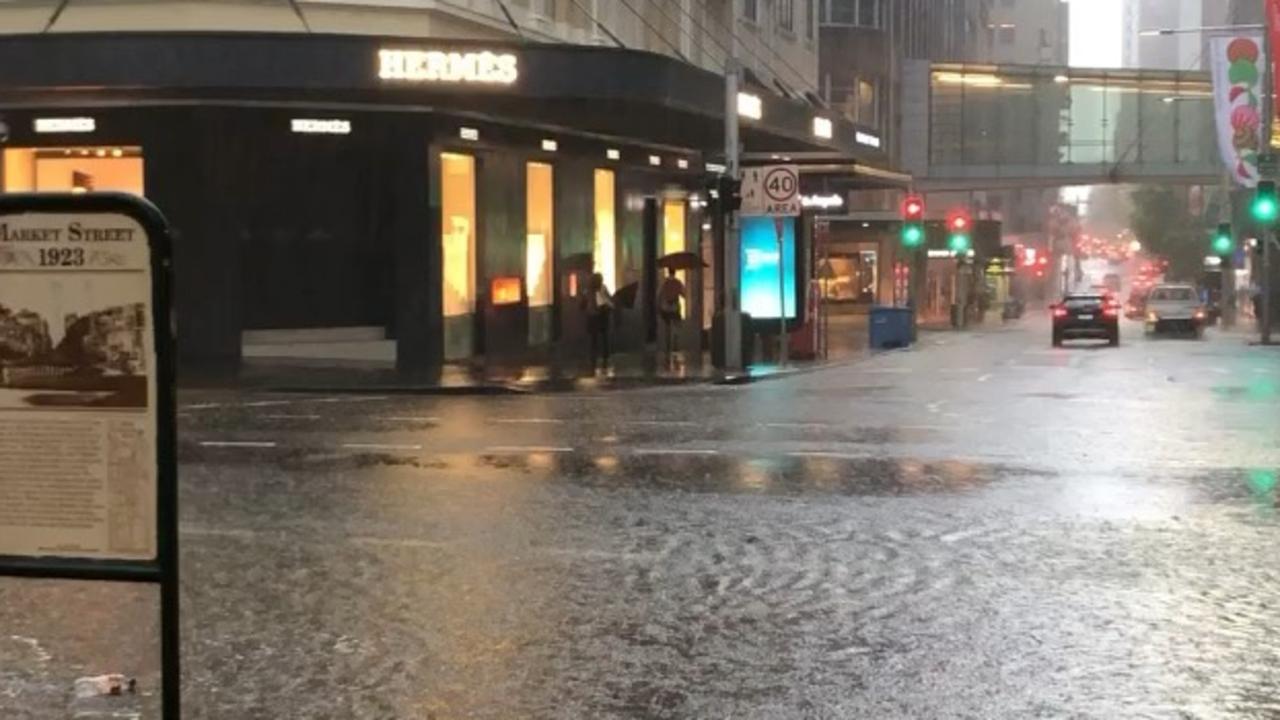 Outside St James Station on Elizabeth St streets are drenched. Picture: Vanessa Pow