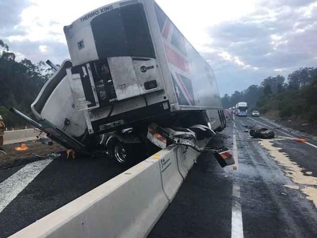 The severely damaged truck somehow landed on the concrete barrier. Picture: Frank Redwood