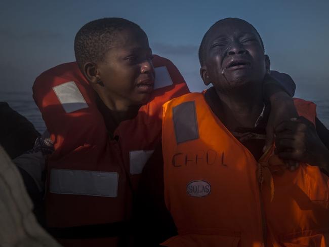 General News - Second Prize, Singles © Santi Palacios Title: Left Alone An 11-year-old girl from Nigeria (left), who said her mother died in Libya, cries next to her 10-year-old brother aboard an NGO rescue boat, on 28 July 2016. The children had sailed for hours in an overcrowded rubber boat with other refugees during a rescue operation on the Mediterranean Sea, about 23 kilometers north of Sabratha, Libya. Libyan smugglers often take advantage of refugees, charging anywhere from $750 to $3500 for a place on typically dangerous boats they say are heading to Italy.