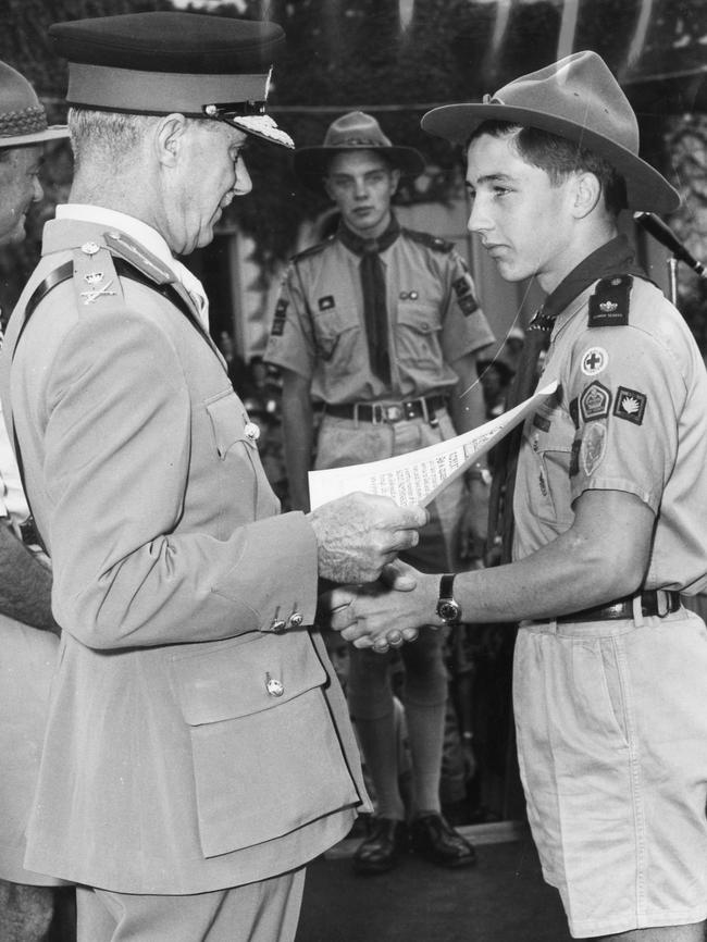 Queen’s Scout Robert Smith of 2nd Kensington Scouts, receives his certificate from the Governor, Sir Edric Bastyan, at a scout rally at Government House, in 1961.