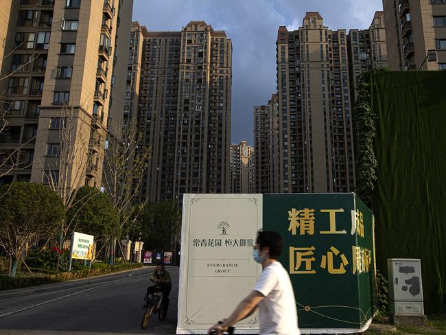 A resident cycles through an Evergrande development in Wuhan. Picture: Getty Images