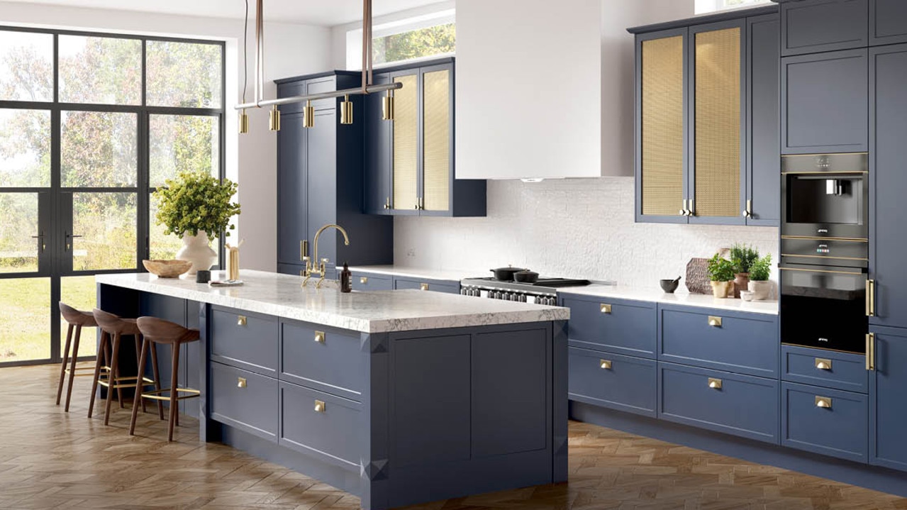 Navy blue kitchen with luxe brass accents and marble look benchtop