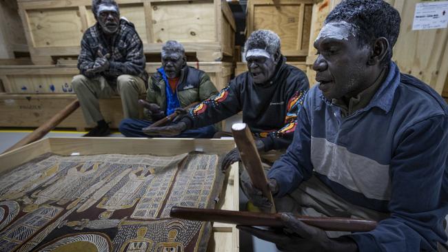 Yolngu artworks are set to depart to the US ahead of an exhibition stateside. Djimbala Ngurruwuthun (left), Bingurr Wirrpanda, Waka Mununggurr and Bandarr Wirrpanda are singing a special ceremonial song to bless the artworks before they can travel and leave the country. Picture: Arsineh Houspian