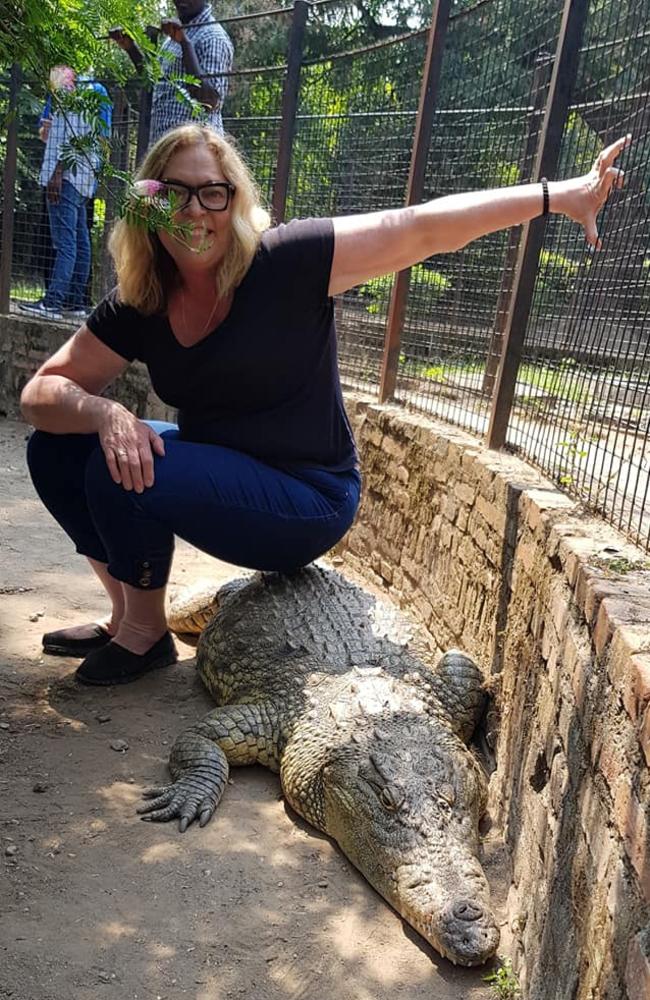 In July 2019 Linda Aitken went to Burundi, posting pictures of herself sitting on a crocodile. Photo: Facebook.