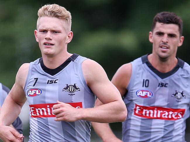 Collingwood footy training at Olympic Park. Taylor Adams, Adam Treloar and Scott Pendlebury do extra running at the end of training.Pic : Michael Klein