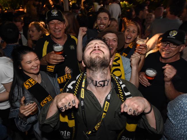 Tigers supporter Fraser Cameron showing off his fake Dusty neck tattoo at the Corner Hotel after the Richmond victory. Picture: Tony Gough