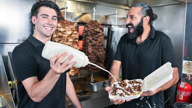 TikTok stars George Fournaros and Takhat Gill prepare an AB with their famous garlic sauce at The Yiros King in Reynella. Picture: Brenton Edwards