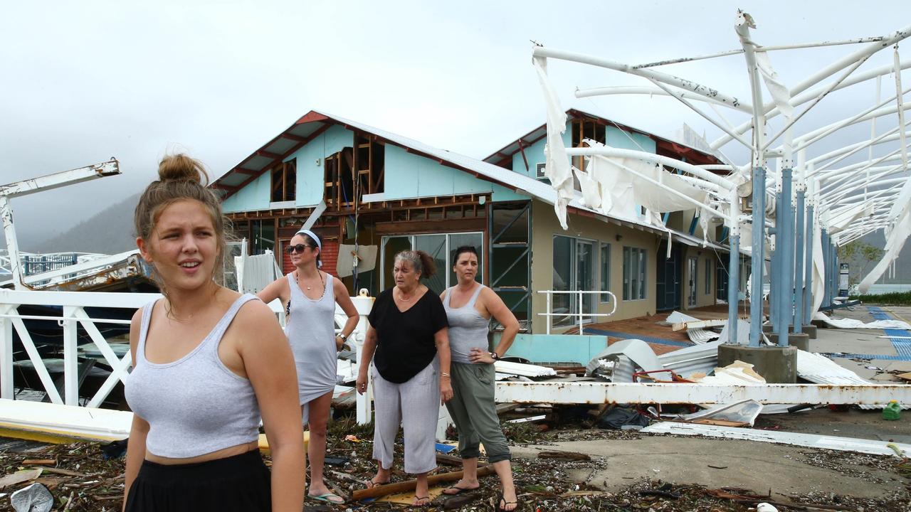 Airlie Beach residents Maika McDonald, 15, Lauren Squires, Karen Gordon, and Katelin Gordon, survey the damage at Shute Harbour after Cyclone Debbie. Photographer: Liam Kidston.