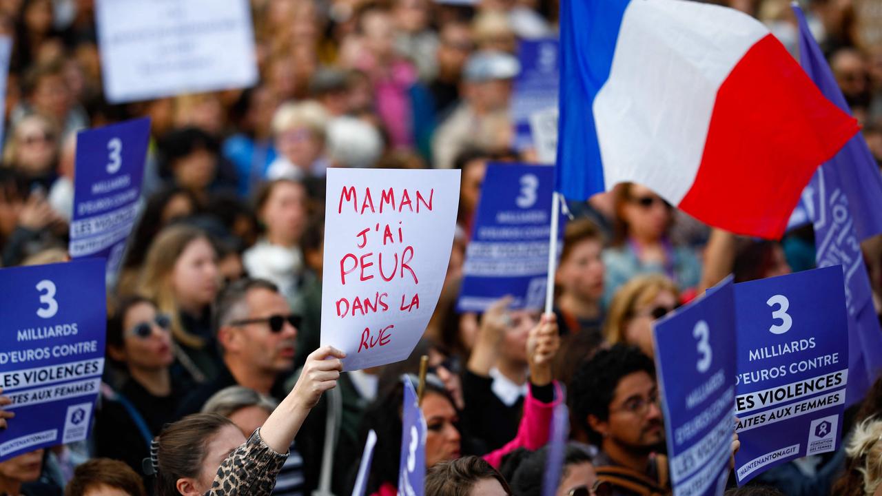 Protesters display placards including one which reads "Mum, I am afraid in the street" as another waves a French flag. Picture: Ian Langsdon/AFP