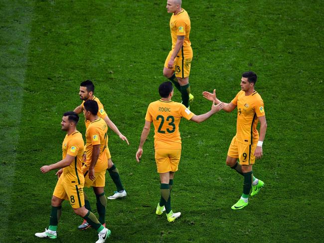 Australia's forward Tommy Rogic is congratulated.