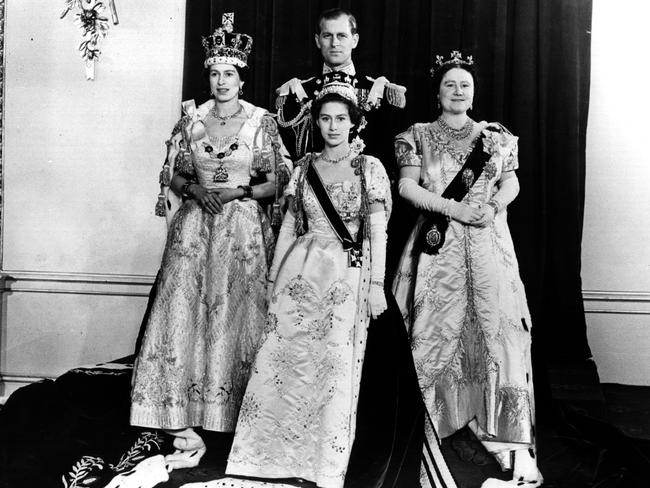 Queen Elizabeth II, (left) with her husband Philip Mountbatten, the Duke of Edinburgh, her mother, Queen Elizabeth and younger sister, Princess Margaret Rose (centre) in the throne room of Buckingham Palace after her Coronation ceremony on June 2, 1953. Princess Margaret died in 2002 at age 71 and Prince Philip died in 2021, aged 99. Picture: Central Press/Getty Images