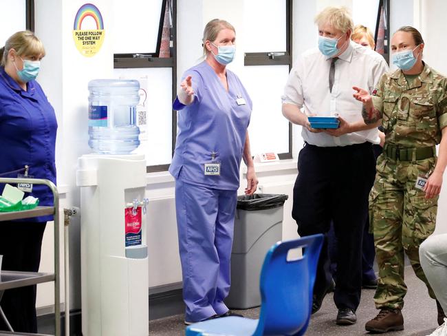 Britain's Prime Minister Boris Johnson (2ndR) scrapped the need for visitors to have pre-departure tests and quarantine on arrival until they have tested negative. Picture: AFP