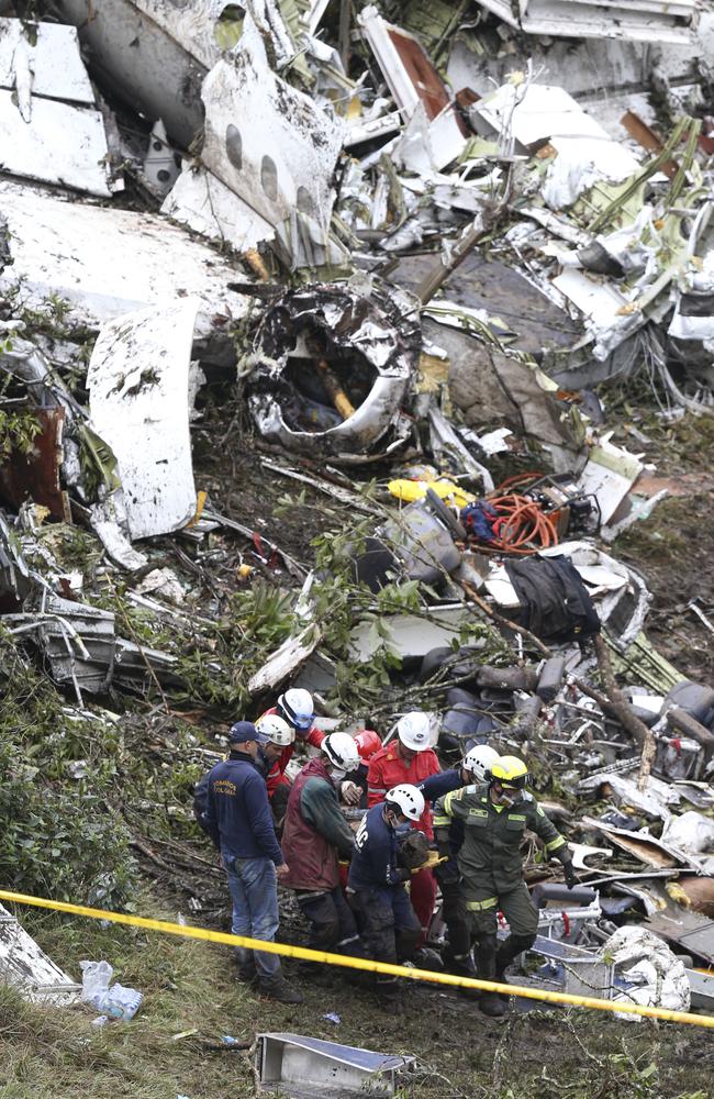 Rescue workers recover a body from the wreckage site in La Union, a mountainous area near Medellin, Colombia. Picture: Fernando Vergara.