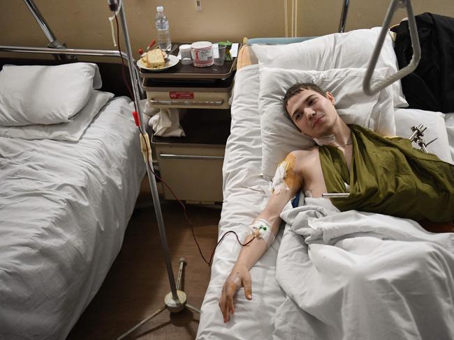 A 19 year old Ukrainian soldier named Yevhen lays in bed in a military hospital in Lviv after being injured by a mine in the Luhansk region. Picture: Daniel Leal / AFP