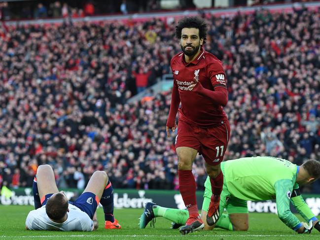 Liverpool's Egyptian midfielder Mohamed Salah (C) celebrates after scoring their third goal during the English Premier League football match between Liverpool and Bournemouth at Anfield in Liverpool, north west England on February 9, 2019. (Photo by Paul ELLIS / AFP) / RESTRICTED TO EDITORIAL USE. No use with unauthorized audio, video, data, fixture lists, club/league logos or 'live' services. Online in-match use limited to 120 images. An additional 40 images may be used in extra time. No video emulation. Social media in-match use limited to 120 images. An additional 40 images may be used in extra time. No use in betting publications, games or single club/league/player publications. /