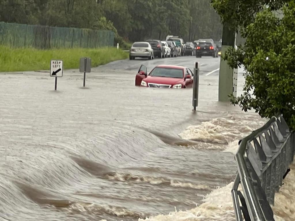 Car abandoned in floodwater at Siganto Drive in Helensvale