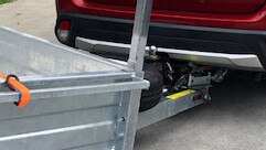 Trailer wedged under Trish Harris's car after an incident at Bunnings Oxenford.