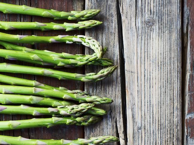 TASTE MATT PRESTON NOV 24: Top view of fresh green asparagus on rustic wooden texture. Food background. Picture: iStock