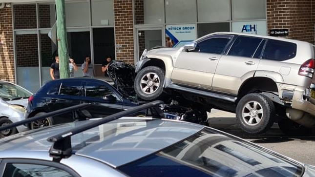 An SUV ended up on top of a black hatchback at a multi-vehicle accident on Helen St, Sefton. Picture: Supplied