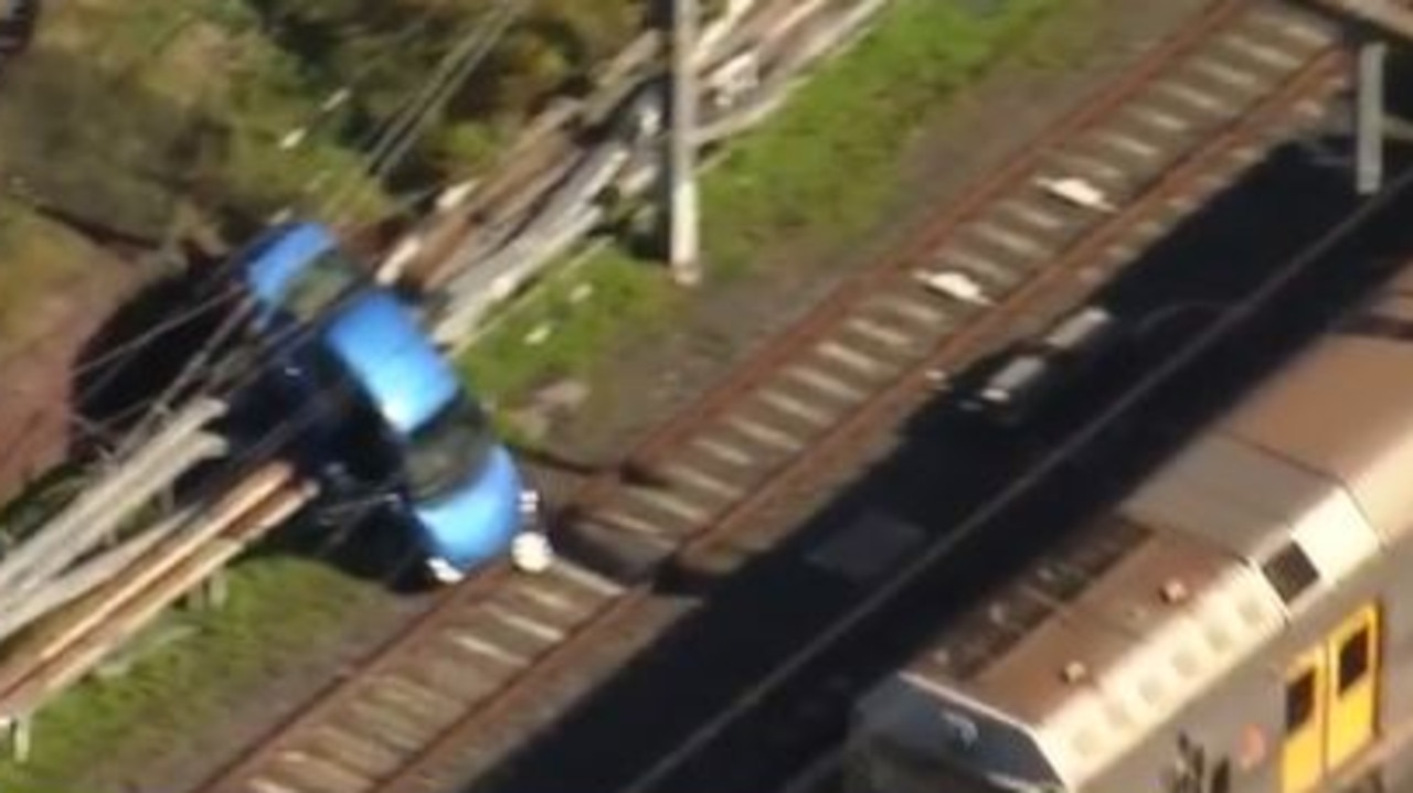 Car smashes through fence onto tracks at Auburn train station | Sky ...