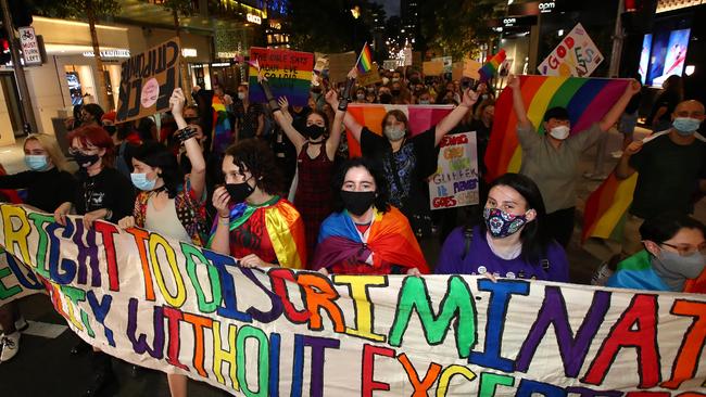 Protesters march as they hold signs during a rally against the Religious Discrimination Bill on February 04, 2022 in Brisbane, Australia. Activists gathered to protest discrimination after Citipointe Christian College asked its students to sign an enrolment contract agreeing to their biological gender and denouncing homosexuality. The principal retracted the policy and apologised but some continue to call for his resignation. Picture: Jono Searle / Getty Images