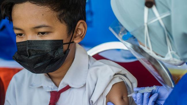 A pupil receives the Chinese Sinovac Covid-19 coronavirus vaccine during a vaccination drive for schoolchildren aged 12-18 in Surabaya, Indonesia. Picture: Juni Kriswanto / AFP