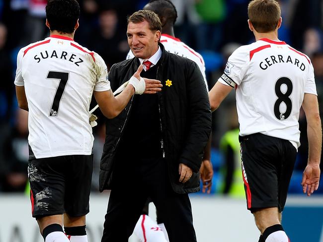 CARDIFF, WALES - MARCH 22: Luis Suarez of Liverpool is congratulated by his manager Brendan Rogers after the final whistle during the Barclays Premier League match between Cardiff City and Liverpool at Cardiff City Stadium on March 22, 2014 in Cardiff, Wales. (Photo by Ben Hoskins/Getty Images)