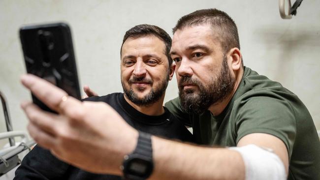 Ukrainian President Volodymyr Zelensky takes a selfie with an injured soldier as he presents medals to soldiers during his visit to a military hospital in Kyiv on November 19. Picture: Mads Claus Rasmussen/AFP