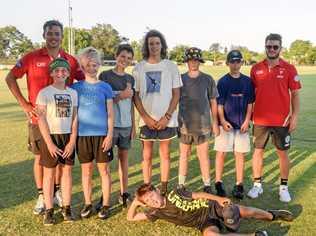 YOUNG GUNS: Sydney Swans players Joel Amartey (far left) and Will Hayward with junior Tigers. Picture: Tim Jarrett