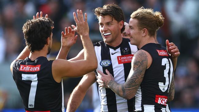 MELBOURNE, AUSTRALIA - APRIL 20: Patrick Lipinski of the Magpies is congratulated by team mates after kicking a goal  during the round six AFL match between Collingwood Magpies and Port Adelaide Power at Melbourne Cricket Ground, on April 20, 2024, in Melbourne, Australia. (Photo by Quinn Rooney/Getty Images)