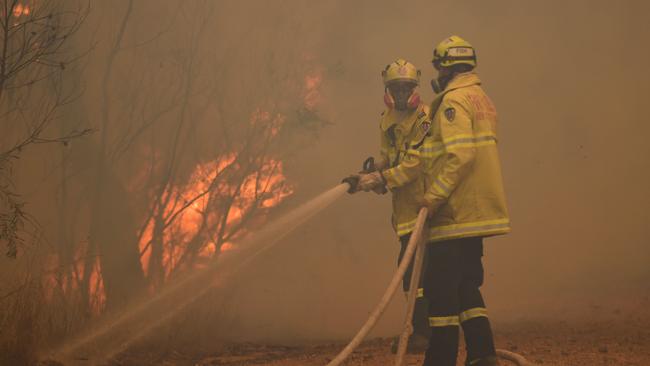 RFS and Fire and Rescue NSW crews continue with containment measures at the out of control Gospers Mountain fire along the Bells Line of Road on Tuesday, December 17. (AAP Image/Dean Lewins)