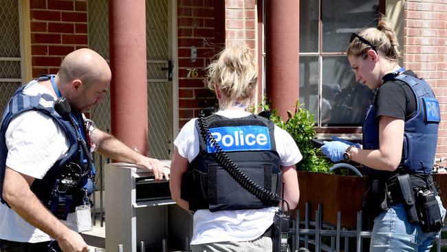 Police making the arrests at a Richmond house last week. Picture: Tony Gough