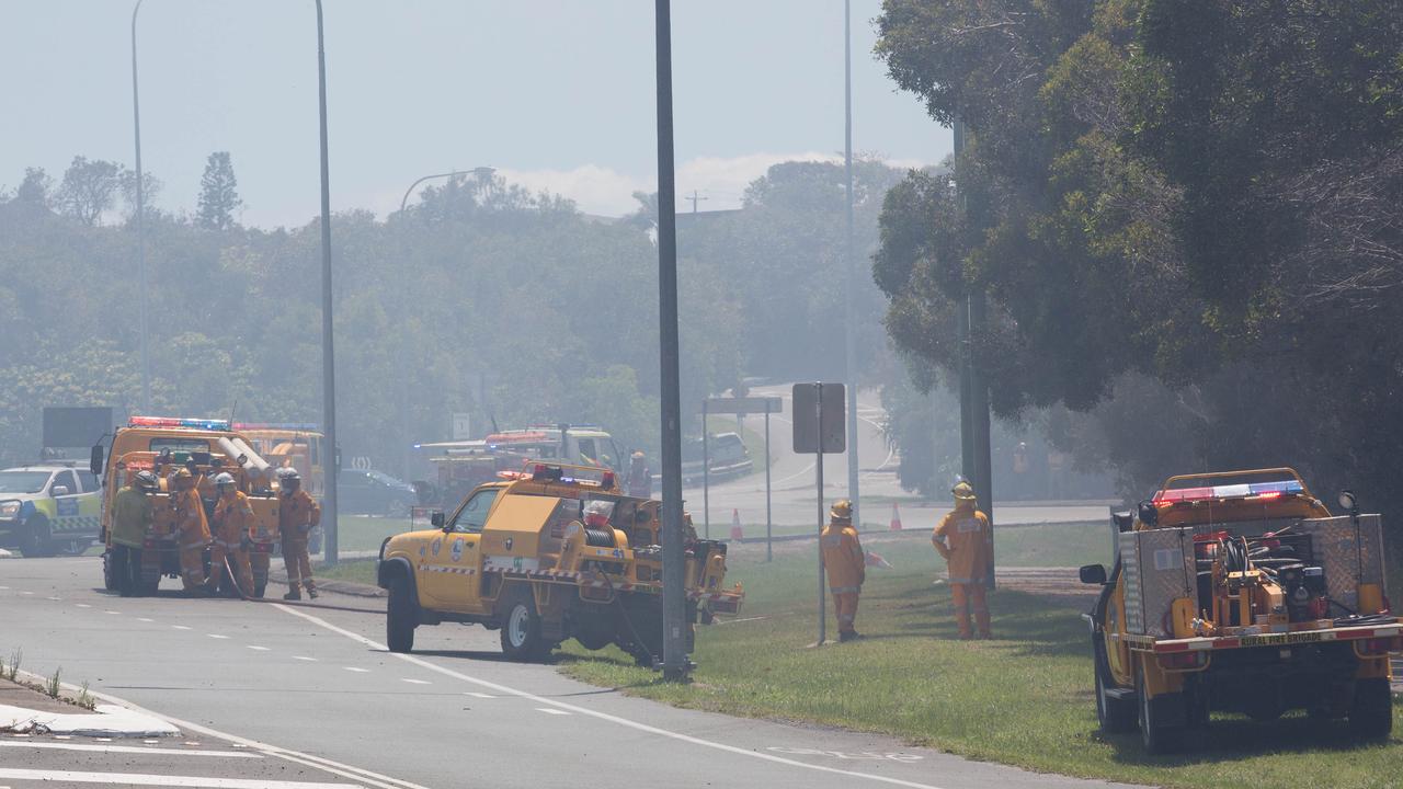 Firefigters work to contain a bushfire at the southern end of Peregian Beach on the border with Coolum Beach, Queensland, Wednesday, October 23, 2019. The fire started north of the Coolum High school and travelled north towards the beach. (AAP Image/Rob Maccoll) NO ARCHIVING